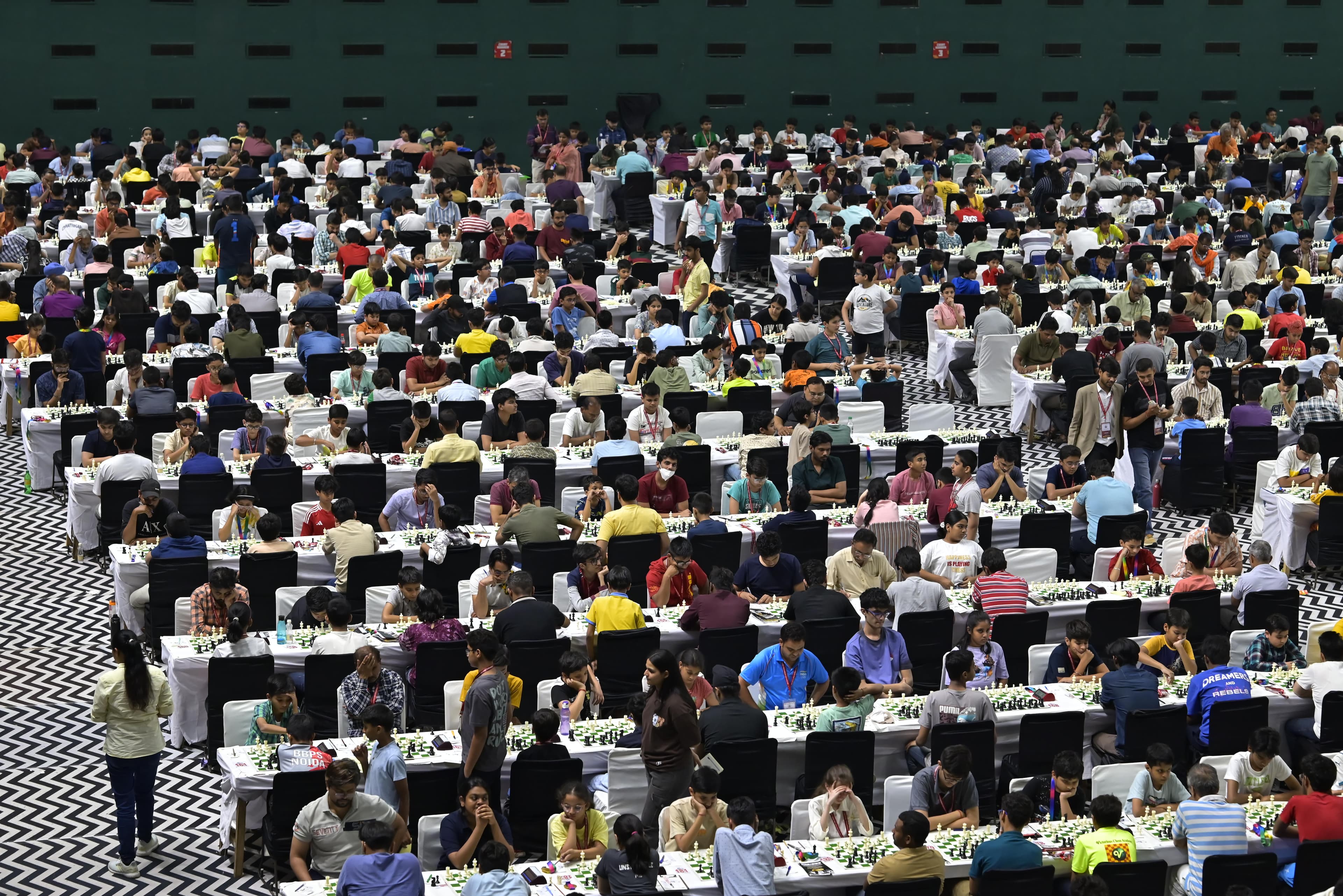 Large chess tournament hall packed with players